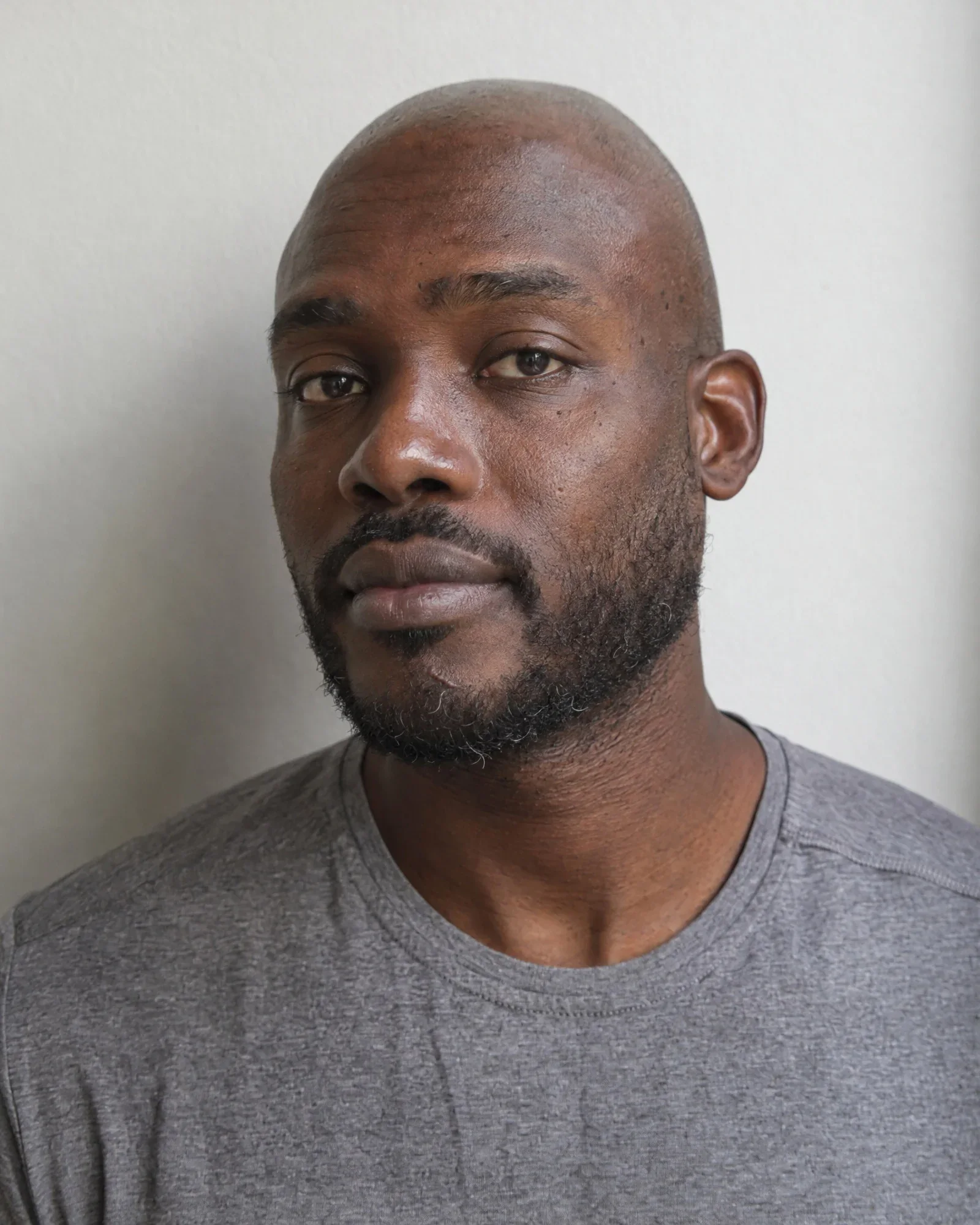 AI model Jesse: Black man around 35 with a shaved head, short beard with some gray, and a small scar on his chin