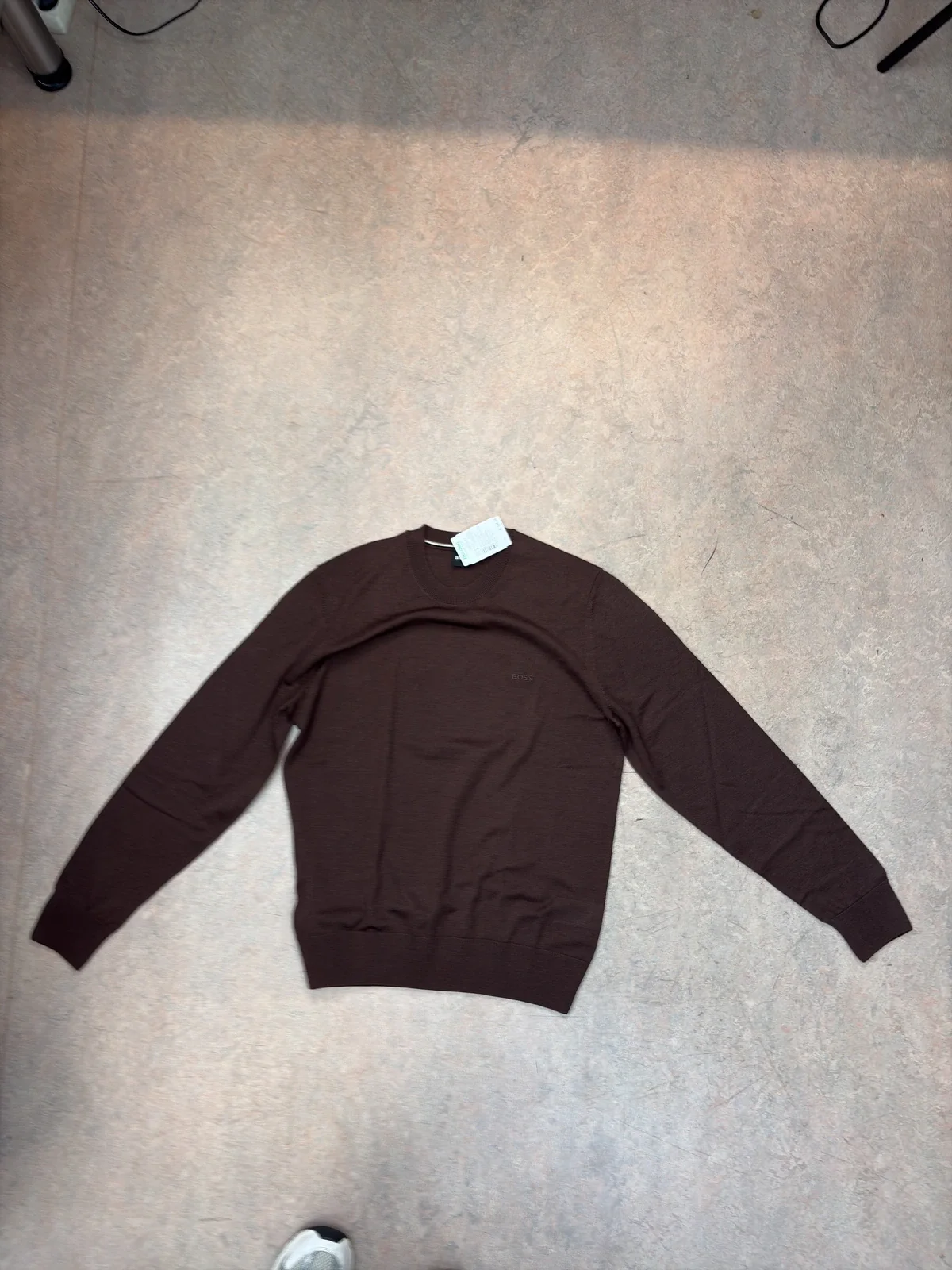 Brown sweater photographed flat on the floor with the app