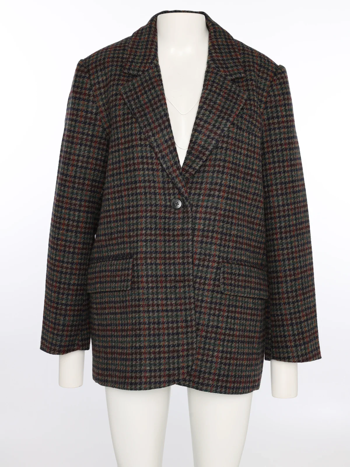 Checkered blazer on a mannequin in the studio