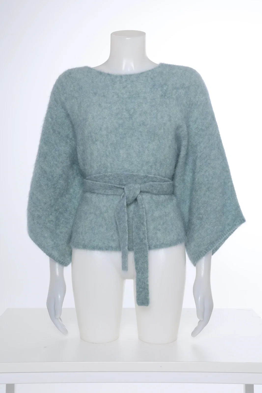 Mint green knitted top with bow belt on a mannequin